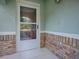 Welcoming front porch with decorative brickwork and a storm door at 307 Stonington Way, Deland, FL 32724