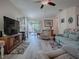 Comfortable living room with access to screened lanai and open floorplan at 307 Stonington Way, Deland, FL 32724