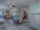 Spacious living room with wood floors, ceiling fan, and an open floorplan at 307 Stonington Way, Deland, FL 32724