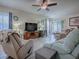 Spacious living room with ceiling fan, wood floors, and sliding glass doors at 307 Stonington Way, Deland, FL 32724