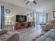 Open living room featuring wood flooring, ceiling fan, and recessed lighting at 307 Stonington Way, Deland, FL 32724