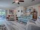 Living room features wood flooring, natural light, and an open floorplan at 307 Stonington Way, Deland, FL 32724