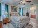 Cozy bedroom with light wood floors, ceiling fan, and en-suite bathroom access at 307 Stonington Way, Deland, FL 32724