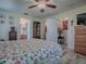 Bedroom featuring wood floors, a ceiling fan, closet, and views into the bathroom at 307 Stonington Way, Deland, FL 32724