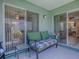 View of a screened patio and patio furniture with views inside the house at 307 Stonington Way, Deland, FL 32724