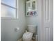 Toilet room featuring neutral walls, white toilet, and cabinet at 307 Stonington Way, Deland, FL 32724