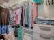 Walk-in closet offers plenty of storage with hanging racks and shelving at 307 Stonington Way, Deland, FL 32724