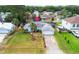 Aerial of a home with a big front lawn, a driveway, and an American flag out front at 3214 Juniper Dr, Edgewater, FL 32141