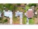 Aerial view of a charming single-Gathering home with a well-maintained lawn, mature trees, a fenced backyard, and a private driveway at 3214 Juniper Dr, Edgewater, FL 32141