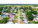 Aerial view of a quaint residential area, featuring well-maintained homes, lush trees, and a friendly, Gathering-oriented atmosphere at 3214 Juniper Dr, Edgewater, FL 32141