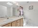 Bathroom features a double vanity, a soaking tub and a glass enclosed shower at 3214 Juniper Dr, Edgewater, FL 32141