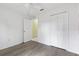 Bright bedroom featuring wood-look floors, closet and ceiling fan at 3214 Juniper Dr, Edgewater, FL 32141