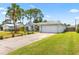 Charming single-story home boasts a well-manicured front yard, spacious driveway, and two-car garage at 3214 Juniper Dr, Edgewater, FL 32141
