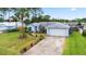 Well-maintained single-story house features a spacious driveway and meticulously landscaped front yard at 3214 Juniper Dr, Edgewater, FL 32141