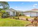 Well-maintained single-story home with a lush lawn and beautiful landscaping at 3214 Juniper Dr, Edgewater, FL 32141