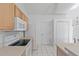 Bright kitchen featuring white appliances and tile flooring at 3214 Juniper Dr, Edgewater, FL 32141