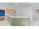 Kitchen featuring a breakfast bar, white appliances, and tile flooring at 3214 Juniper Dr, Edgewater, FL 32141