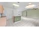 Bright, open kitchen with an island bar and white tile floors at 3214 Juniper Dr, Edgewater, FL 32141
