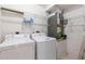 Laundry room with washer, dryer, and wire shelving at 3214 Juniper Dr, Edgewater, FL 32141