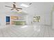 Bright open-concept living room leading to kitchen with island and breakfast bar seating at 3214 Juniper Dr, Edgewater, FL 32141