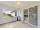 Covered patio with tile flooring, and sliding glass door to the kitchen at 3214 Juniper Dr, Edgewater, FL 32141