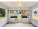 Enclosed screen porch with tiled floor offering views of the backyard at 3214 Juniper Dr, Edgewater, FL 32141