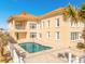 A private backyard with a spacious pool, and a balcony overlooking the pool at 33 Ocean Shore Blvd, Ormond Beach, FL 32176