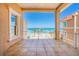 Tile balcony offering ocean views, white railings, and a covered seating area at 33 Ocean Shore Blvd, Ormond Beach, FL 32176