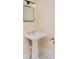 Bathroom featuring pedestal sink and classic fixtures, providing a clean and functional space at 33 Ocean Shore Blvd, Ormond Beach, FL 32176