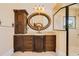Bathroom featuring wood cabinets, decorative mirrors, and walk-in shower at 33 Ocean Shore Blvd, Ormond Beach, FL 32176
