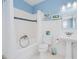 Bright bathroom with white subway tile, blue accents, and a pedestal sink at 33 Ocean Shore Blvd, Ormond Beach, FL 32176