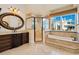 Elegant bathroom with marble floors, granite counters, soaking tub and walk-in shower at 33 Ocean Shore Blvd, Ormond Beach, FL 32176