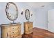 Bathroom with ornate dual vanities, unique mirrors, and hardwood floors at 33 Ocean Shore Blvd, Ormond Beach, FL 32176