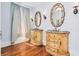 Bathroom featuring dual vanities, ornate mirrors, sconces and hardwood floors at 33 Ocean Shore Blvd, Ormond Beach, FL 32176