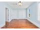 Bedroom with light blue walls, wood floors, two closets and two windows at 33 Ocean Shore Blvd, Ormond Beach, FL 32176