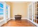Bright room featuring hardwood floors, ocean views, and stylish dresser with French doors at 33 Ocean Shore Blvd, Ormond Beach, FL 32176
