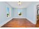 Empty bedroom with blue walls, hardwood floors, and two windows overlooking the street at 33 Ocean Shore Blvd, Ormond Beach, FL 32176