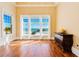 Bright bedroom with hardwood floors and large windows that overlook an ocean view at 33 Ocean Shore Blvd, Ormond Beach, FL 32176