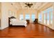 Bright bedroom with coffered ceilings, water view, and access to a balcony at 33 Ocean Shore Blvd, Ormond Beach, FL 32176
