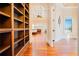 Bright bedroom with hardwood floors, built-in shelves, and archway views of ocean at 33 Ocean Shore Blvd, Ormond Beach, FL 32176