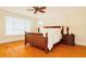 Spacious bedroom with a ceiling fan, wood floors, and windows allowing plenty of natural light at 33 Ocean Shore Blvd, Ormond Beach, FL 32176