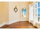 Sunny bedroom with large windows offering ocean views, hardwood floors, and decorative mirror at 33 Ocean Shore Blvd, Ormond Beach, FL 32176