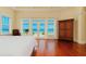 Bedroom with French doors, wooden floors, and ocean view at 33 Ocean Shore Blvd, Ormond Beach, FL 32176
