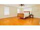 Bedroom featuring wood floors, ceiling fan and large windows at 33 Ocean Shore Blvd, Ormond Beach, FL 32176