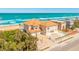 Spacious beach home featuring a grand entrance, lush landscaping, and a two-car garage at 33 Ocean Shore Blvd, Ormond Beach, FL 32176