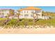 Stunning multi-level home on sandy beach with lush landscaping and inviting balconies at 33 Ocean Shore Blvd, Ormond Beach, FL 32176