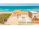 Stunning oceanfront home with a private sandy beach, garage, and white picket fence at 33 Ocean Shore Blvd, Ormond Beach, FL 32176