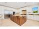 Kitchen featuring a large island, stainless steel appliances, granite counters, and custom cabinetry, offering a chef's delight at 33 Ocean Shore Blvd, Ormond Beach, FL 32176