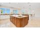 Open kitchen featuring granite countertops, custom cabinets, a center island, and views of the ocean beyond at 33 Ocean Shore Blvd, Ormond Beach, FL 32176