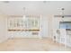 Bright and open kitchen with white cabinetry, granite countertops, stainless steel appliances, and a beautiful chandelier at 33 Ocean Shore Blvd, Ormond Beach, FL 32176